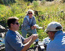 Perry Converse explaining the Winkler Titration method for determining dissolved oxygen content to Ann Francis and Todd Sloat.